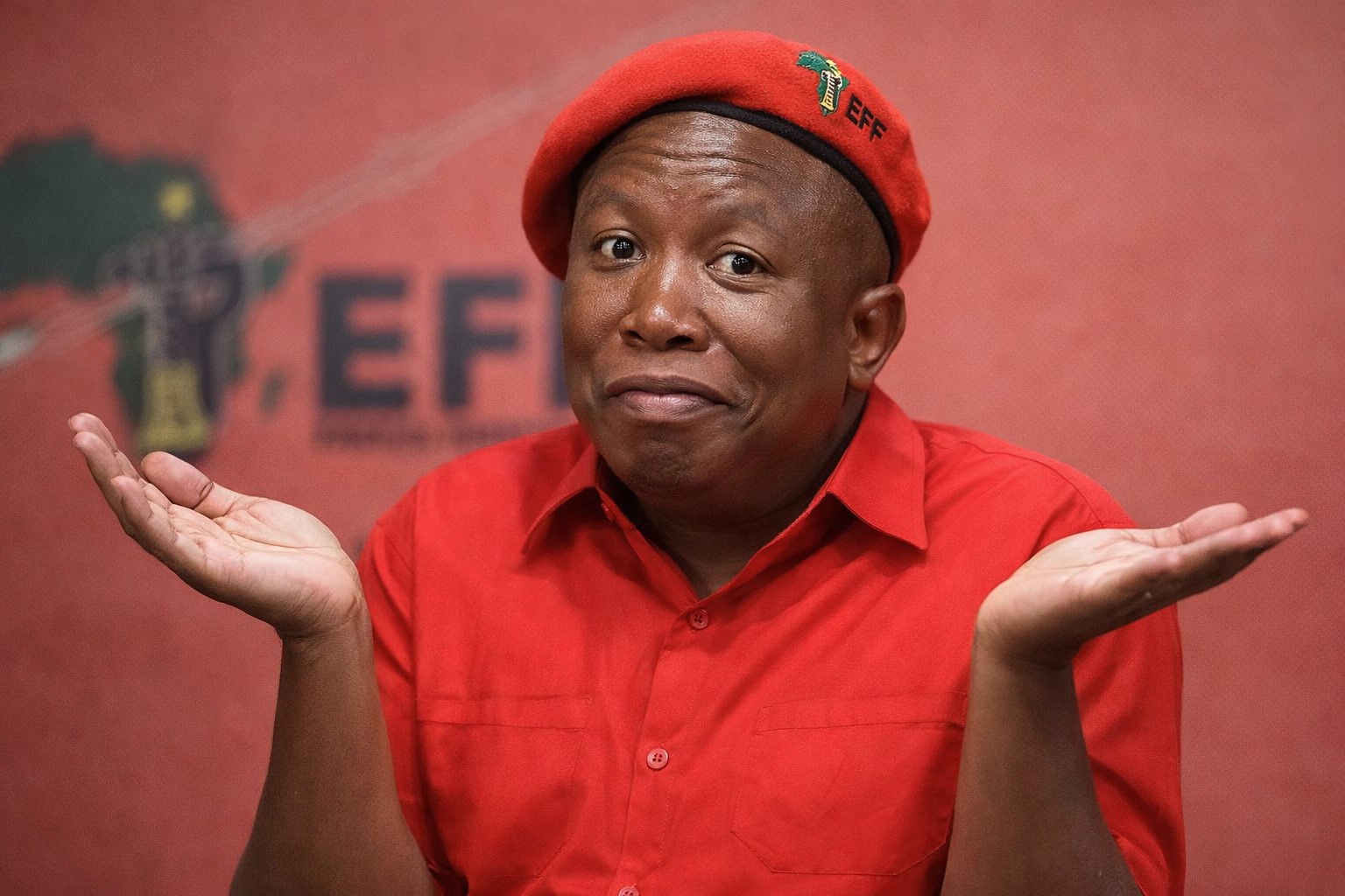 Malema-in-red-with-open-hands.jpg